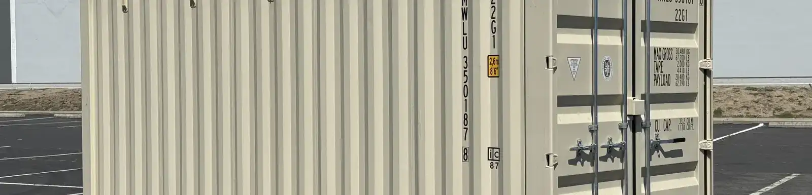 New one-trip shipping container in clean condition with cargo doors, corrugated steel walls, and minimal wear in a container yard.
